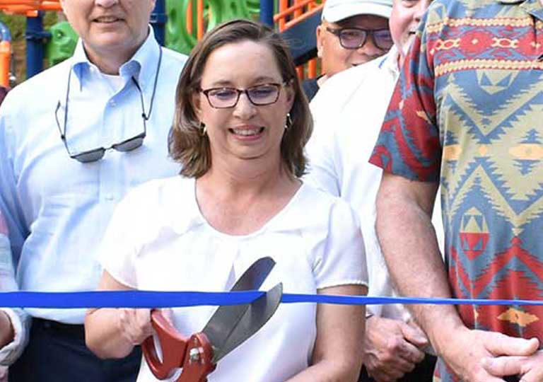 Cara Schroeder citizen of the month cutting the ribbon for a playground