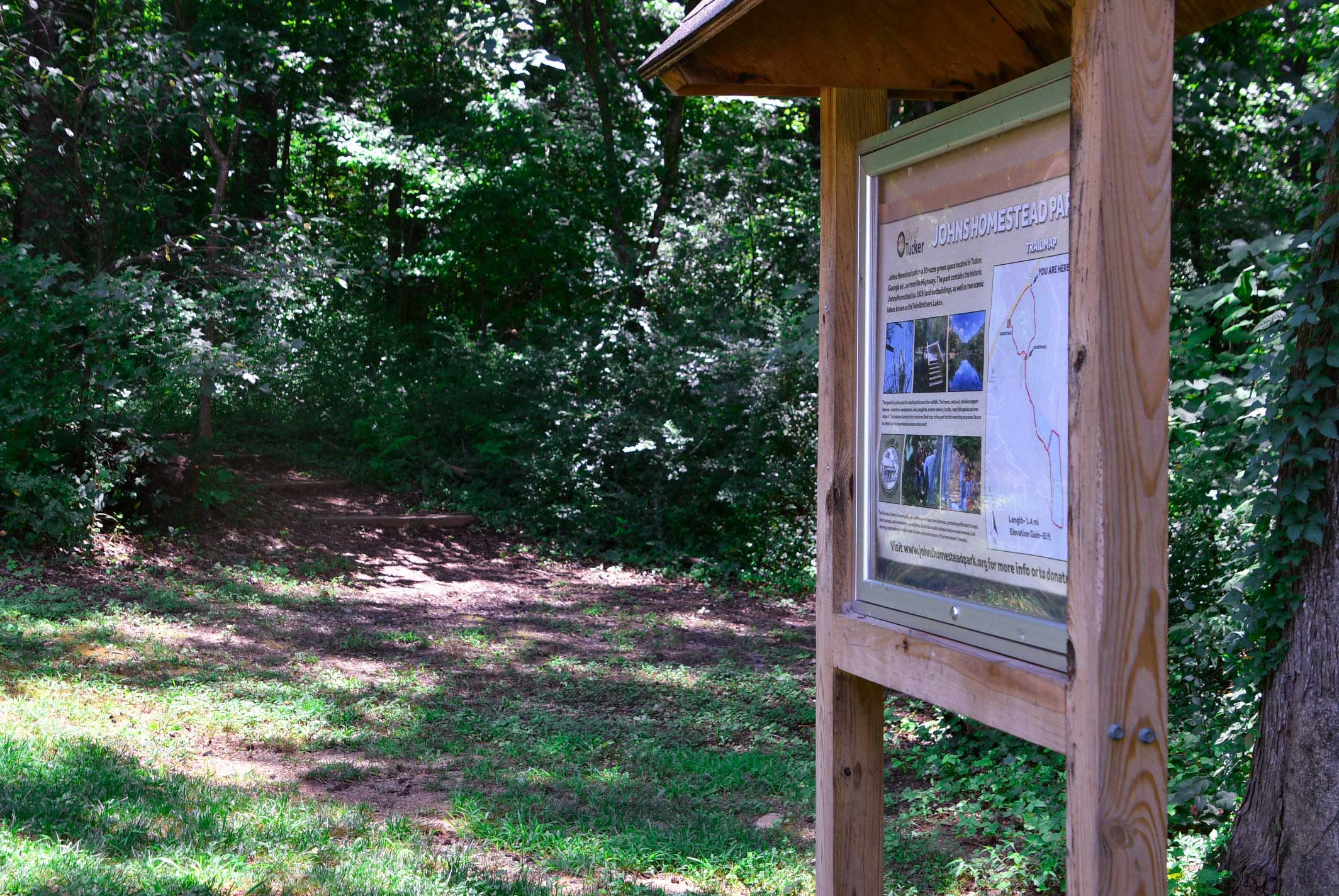 The welcome kiosk and sign at Johns homestead