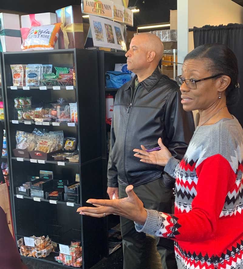 Owners stands and talks with customers in her shop