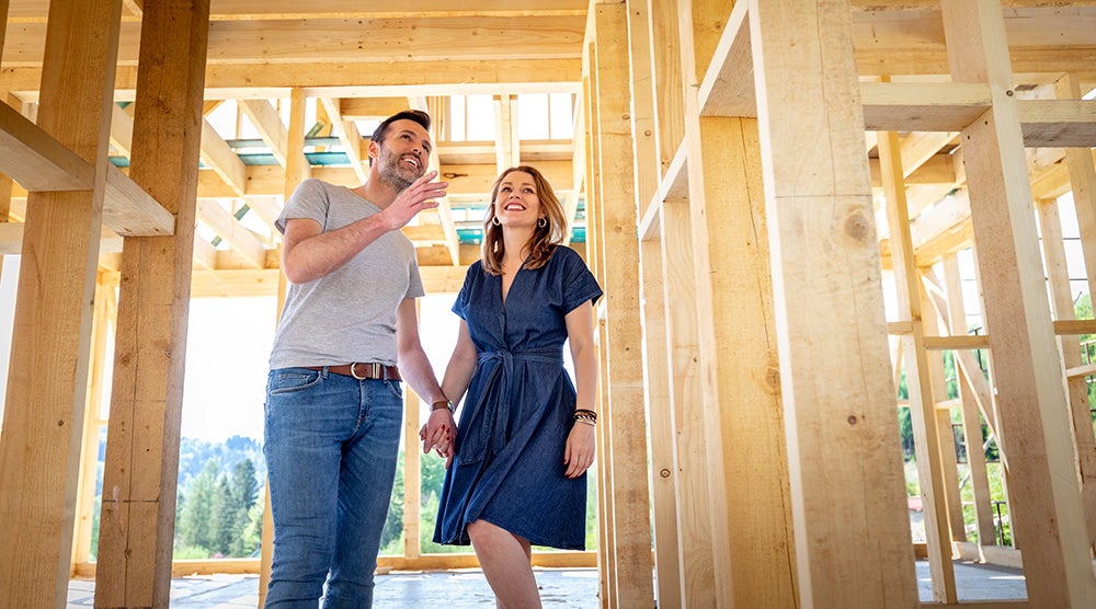 Couple Building Their Own Home Visiting House Under Construction