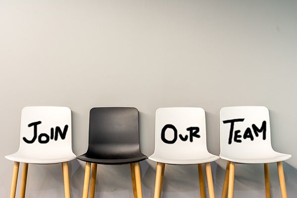 Row of chairs with Join. Our. Team. written across them