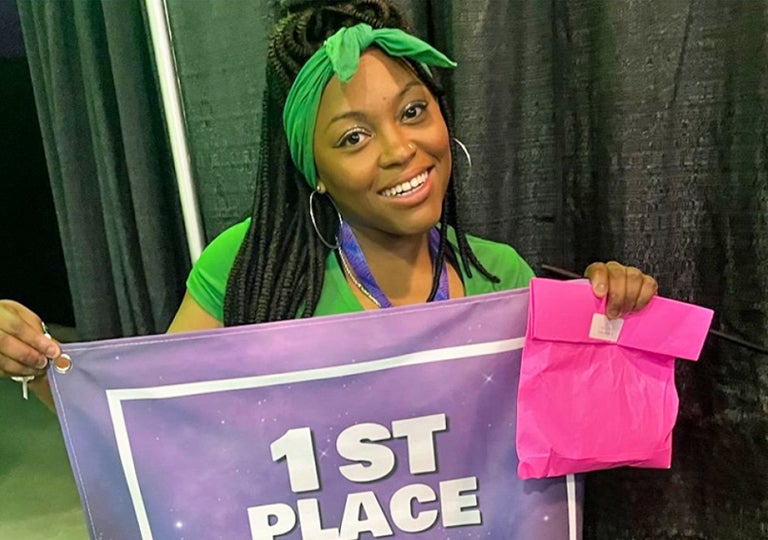 Destini Copeland, a black teenager With First place flag, citizen of the month