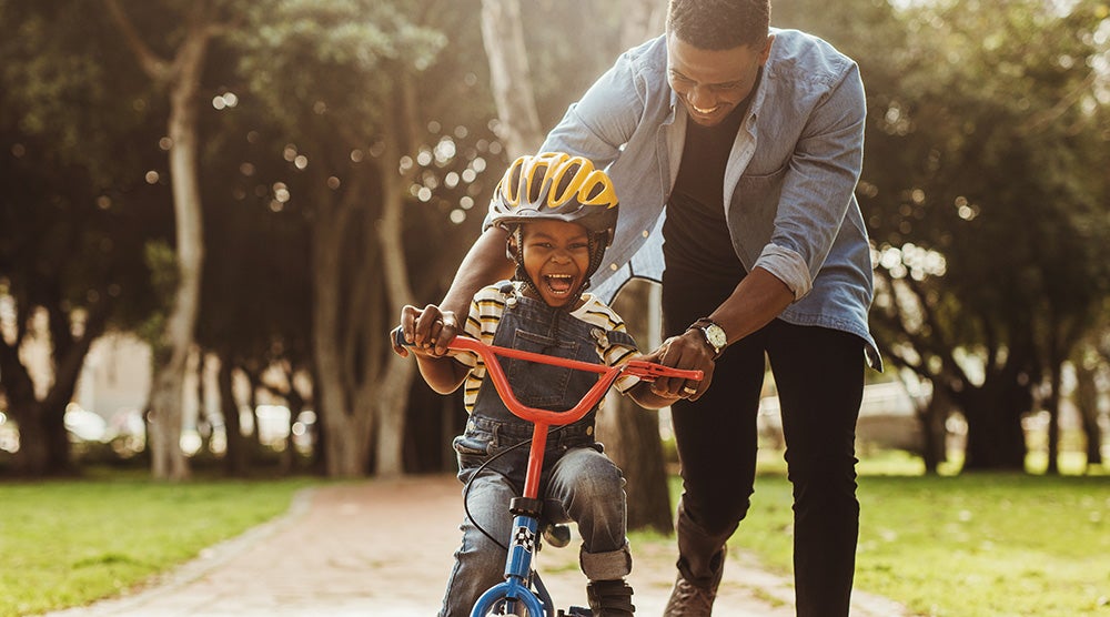 Father Teaching his Son Cycling at a Park