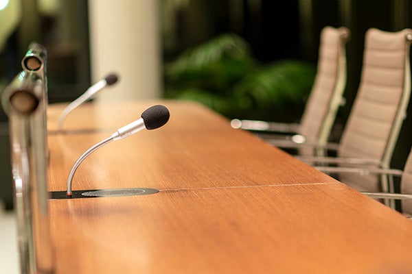 Microphones standing on a highly polished conference table