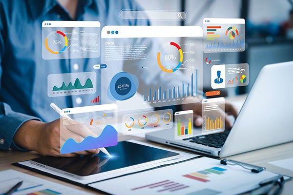 An analyst uses a computer and dashboard for data business analysis.