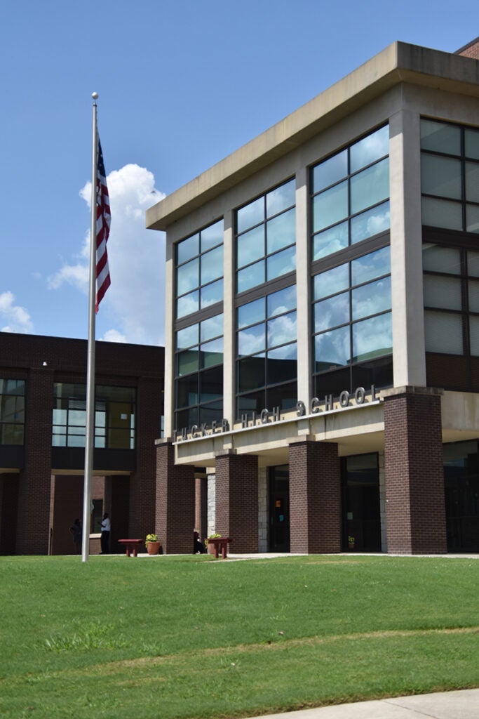 Outside of Tucker High School on a sunny day with reflective windows