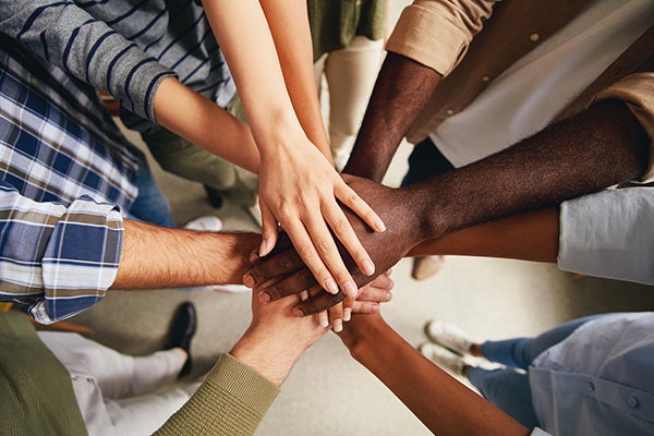 Cropped photo of multiracial people hands put on top of each other