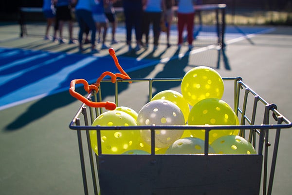 bin of pickleballs