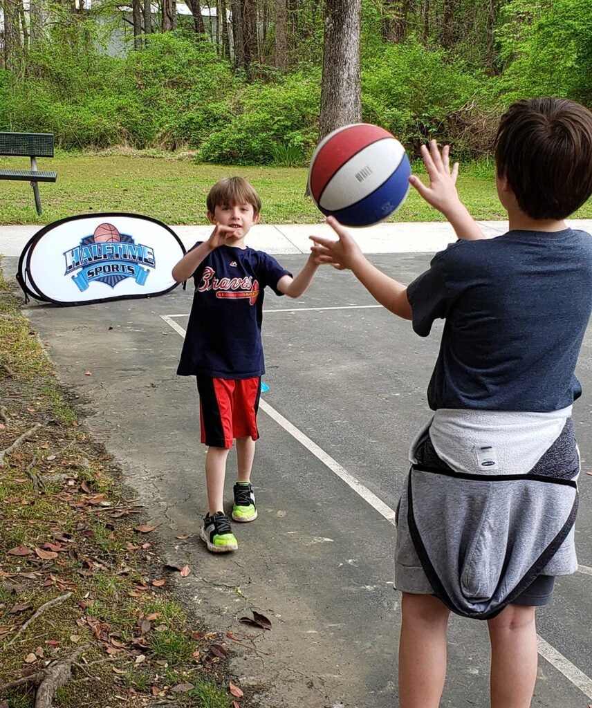 Two children playing basketball.