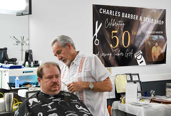 Environmental portrait of Charles Mason in his barbershop.