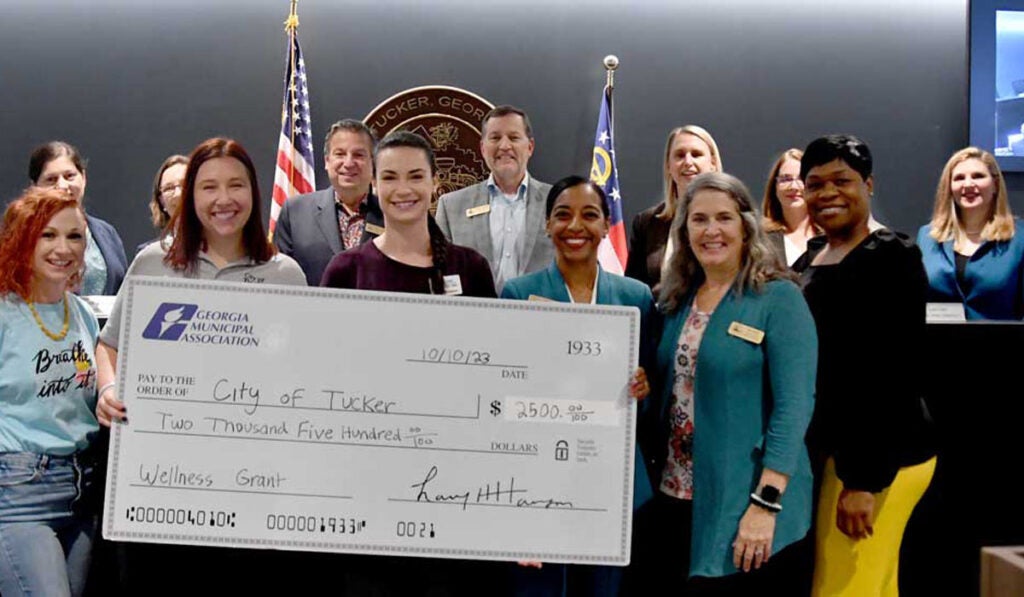 GMA presents oversize check to Tucker Wellness Committee members.