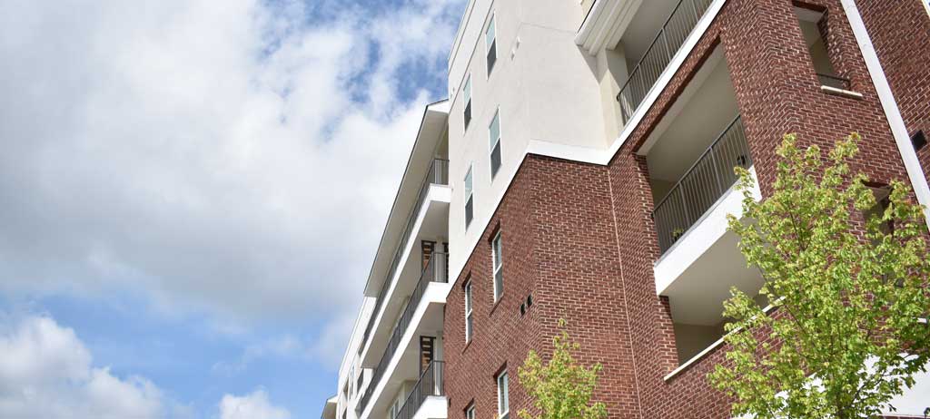 Looking up at Northlake Senior Apartments and sky