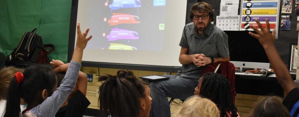 STEM teacher in a classroom with small children