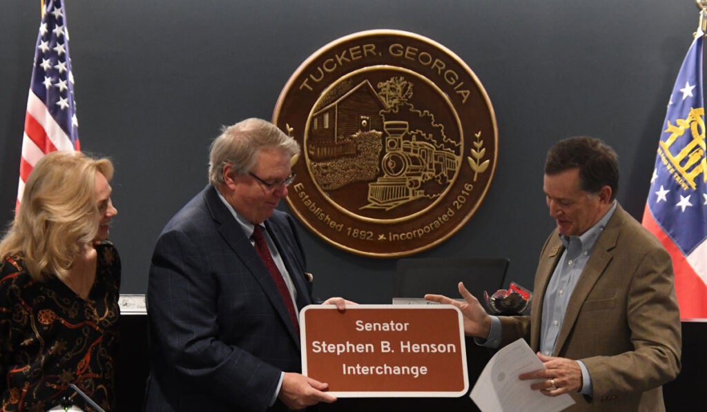 Senator Steve Henson receives his replica interchange sign from Mayor Auman.