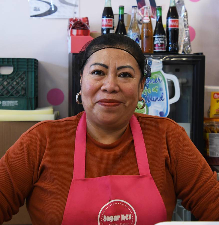 SUgar Mex owner Maria Salazar smiles from behind the counter,