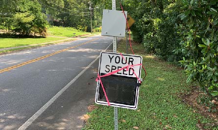 Broken speed detection sign that was tied to pole.