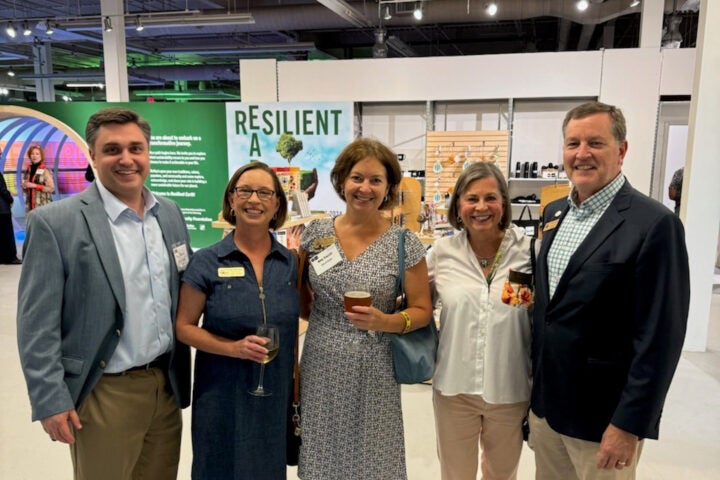 Councilmembers Cara Schroeder and Amy Trocchi pose with Mayor Auman at the Resilient Earth exhibit in the Science Gallery Atlanta.