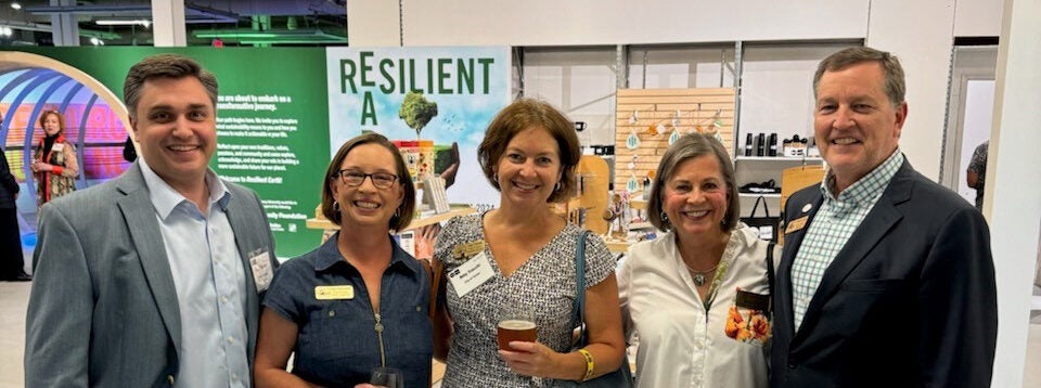 Councilmembers Cara Schroeder and Amy Trocchi pose with Mayor Auman at the Resilient Earth exhibit in the Science Gallery Atlanta.