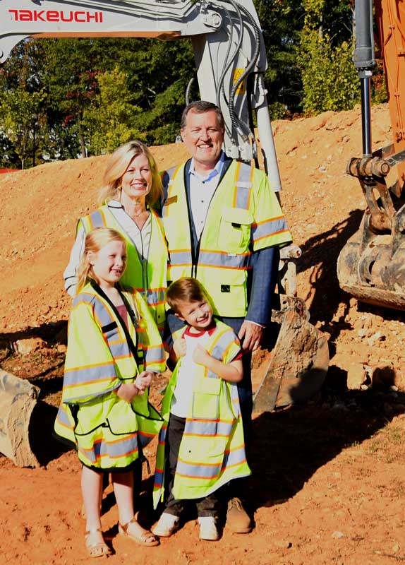 Mayor Auman and Gaye Auman pose with two grandchildren.