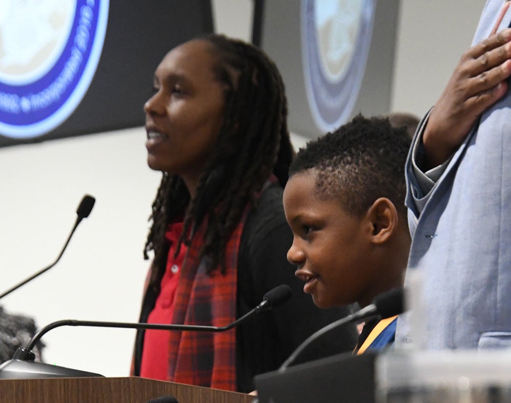 Coach Lakita Ford, former City of Tucker Athletics Manager, and King Murphy of the Tucker Express Basketball League lead the Pledge of Allegiance.