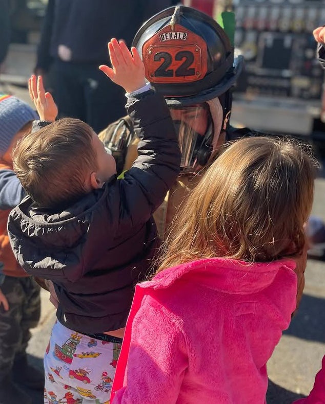 Children meet a DeKalb firefighter at Turning Sun